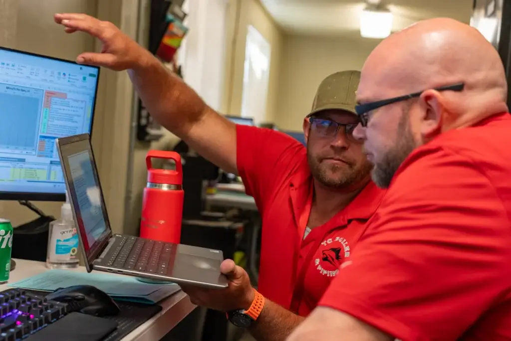 Two men from TC Boiler & Piping discuss Project Controls